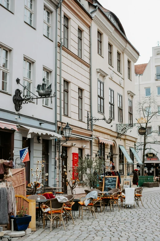 a cobblestone street in a european city, by Tobias Stimmer, trending on unsplash, art nouveau, market stalls, white, coastal, retro style ”
