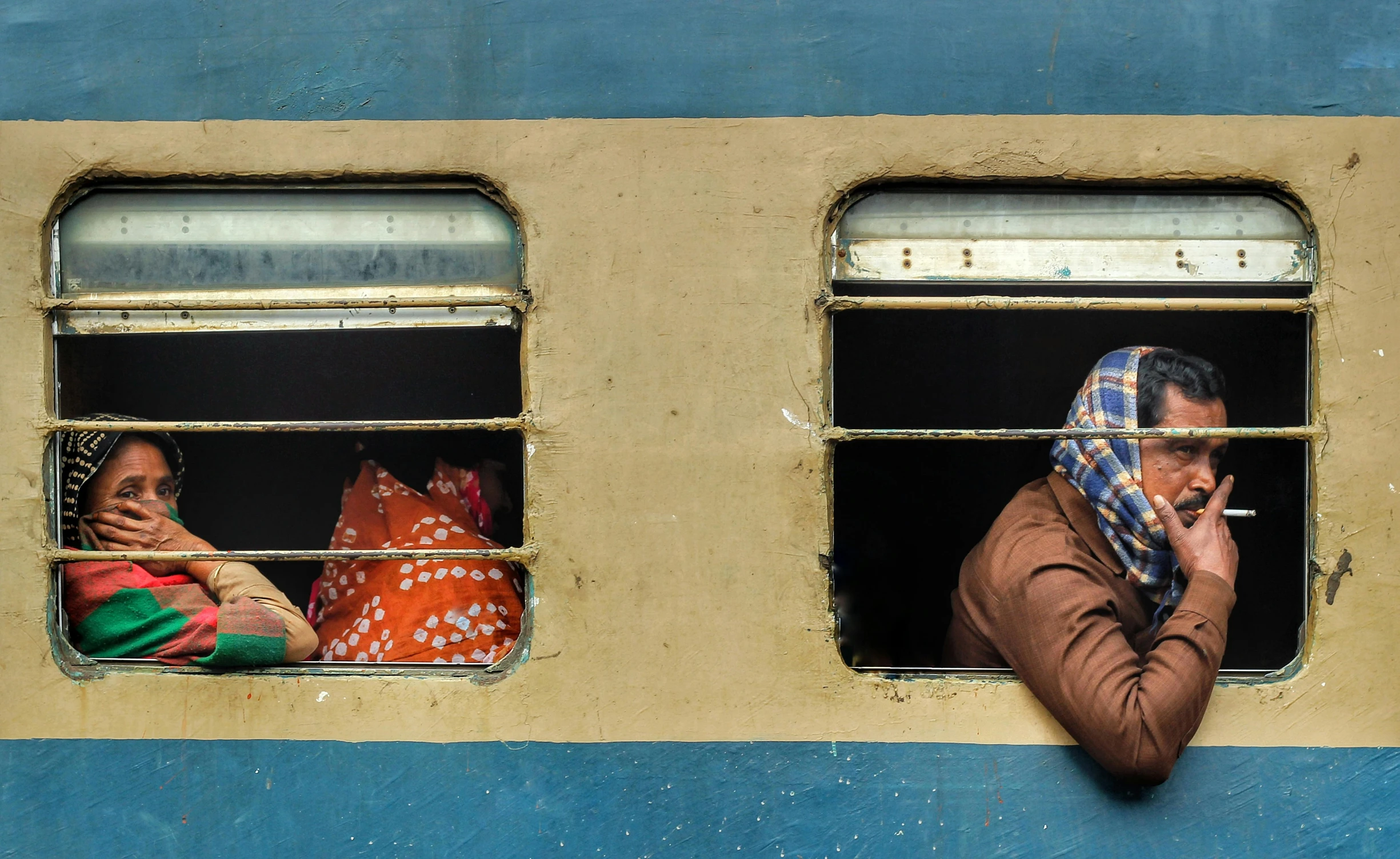 a couple of people that are looking out of a window, inspired by Steve McCurry, pexels contest winner, hyperrealism, sat down in train aile, hindu, square, gettyimages