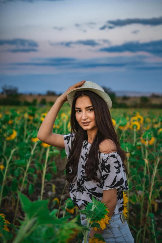 a woman standing in a field of sunflowers, a picture, by irakli nadar, pexels contest winner, handsome girl, isabela moner, with hat, avatar image