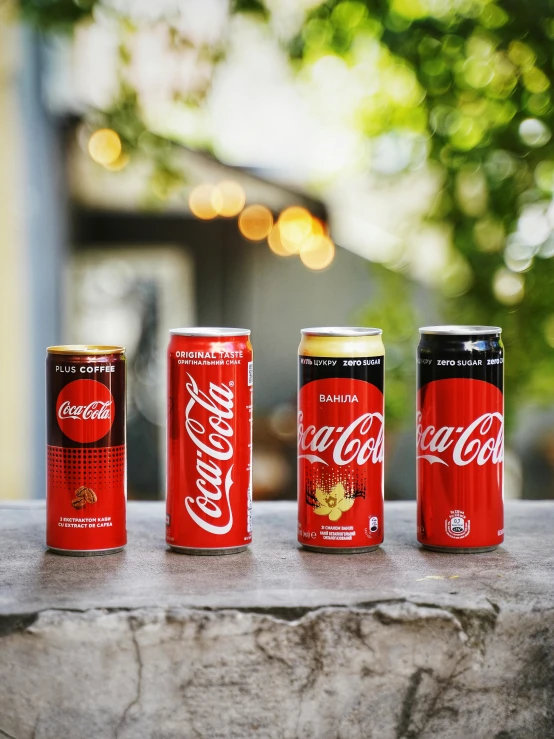 four cans of coke are lined up on a ledge, an award winning masterpiece, al fresco, collection product, 🦩🪐🐞👩🏻🦳