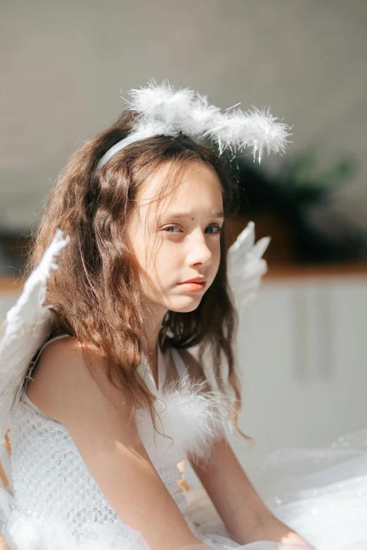 a little girl dressed as an angel sitting on a bed, trending on pexels, young angry woman, feather hair, gif, teen elf