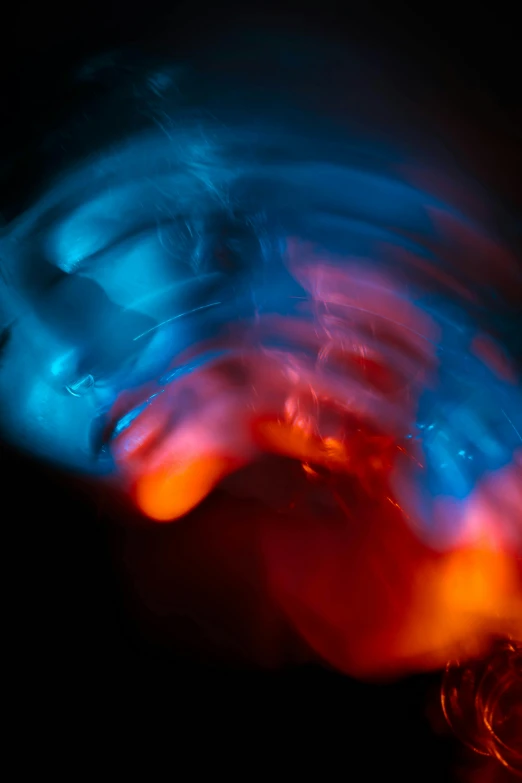 a blurry photo of a person playing with a frisbee, an abstract sculpture, flickr, light and space, orange fire/blue ice duality!, closeup of face melting in agony, blue and red glowing lights, fractal waves