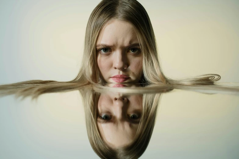 a close up of a person with long hair, inspired by Anna Füssli, unsplash, hyperrealism, angry at mirror, elle fanning as an android, half submerged, looking straight into camera