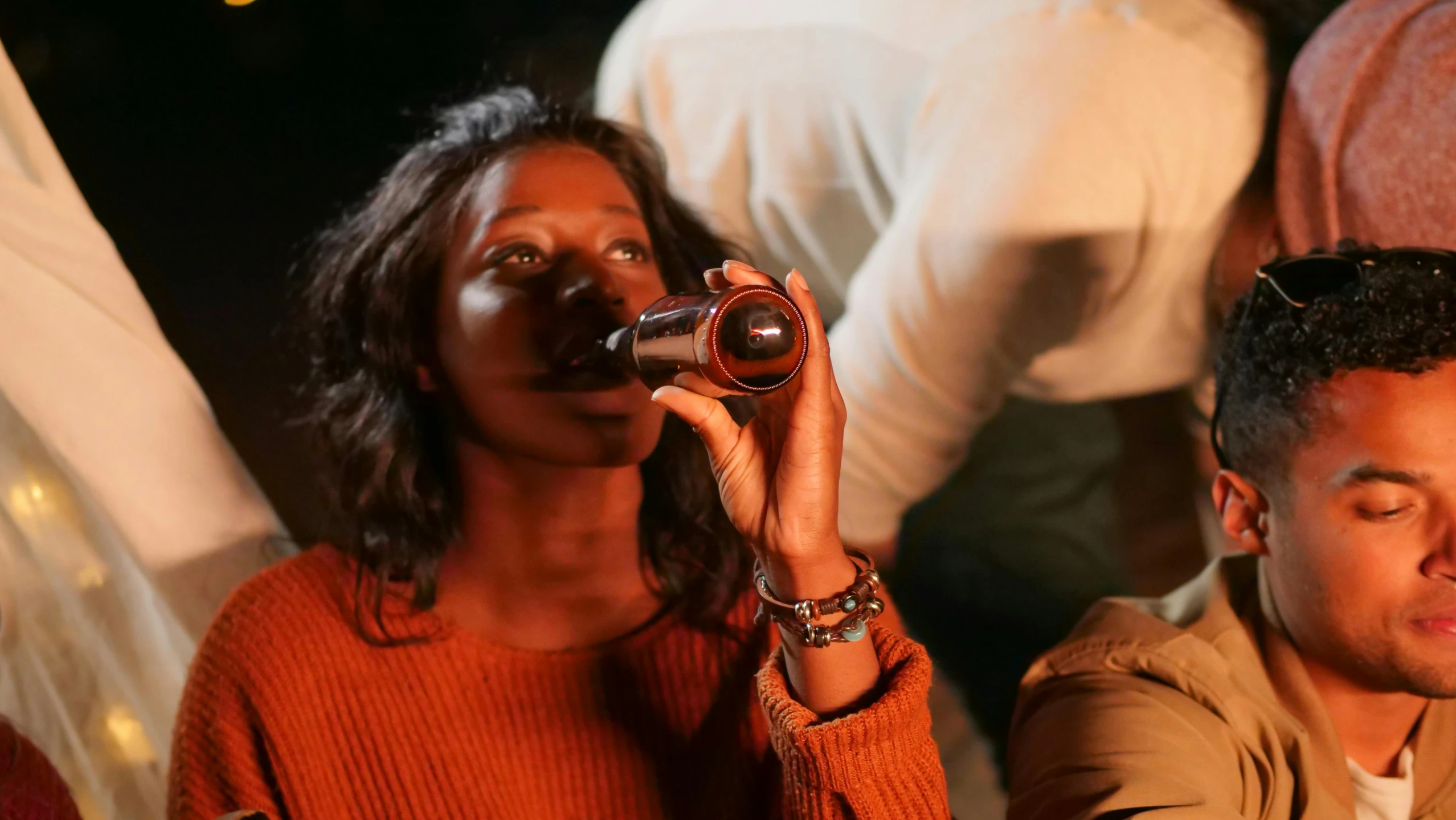 a man and a woman sitting next to each other, pexels contest winner, hurufiyya, drinking a bottle of coca-cola, dark skinned, flares anamorphic, with brown skin