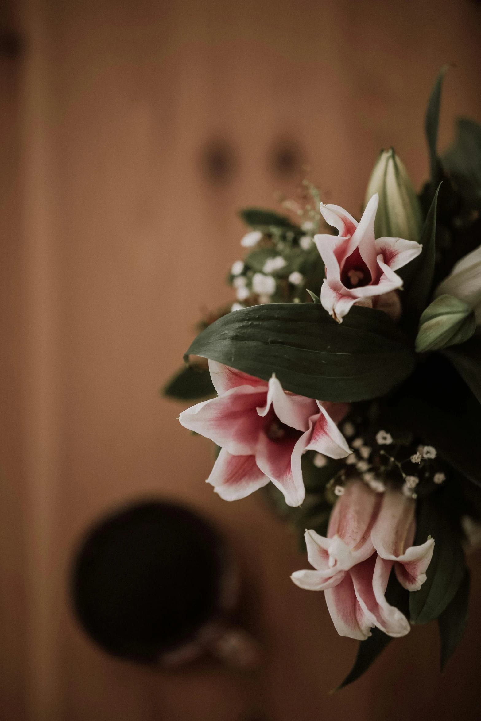 a bouquet of flowers sitting on top of a table, lillies, up close, atmospheric photograph, pinks