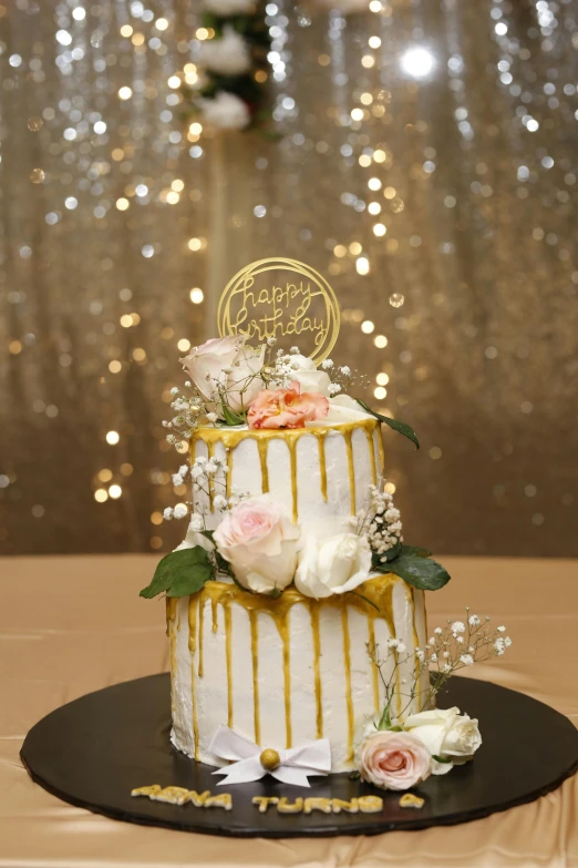 a wedding cake sitting on top of a table, gold raining in the background, happy birthday, flowers and gold, no cropping