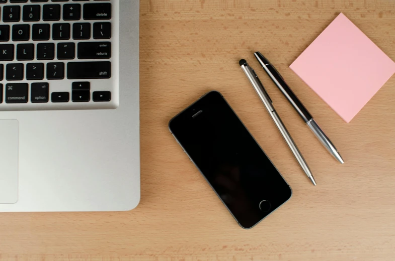 a laptop computer sitting on top of a wooden desk, by Carey Morris, trending on unsplash, square, iphone 13, maintenance, smartphone