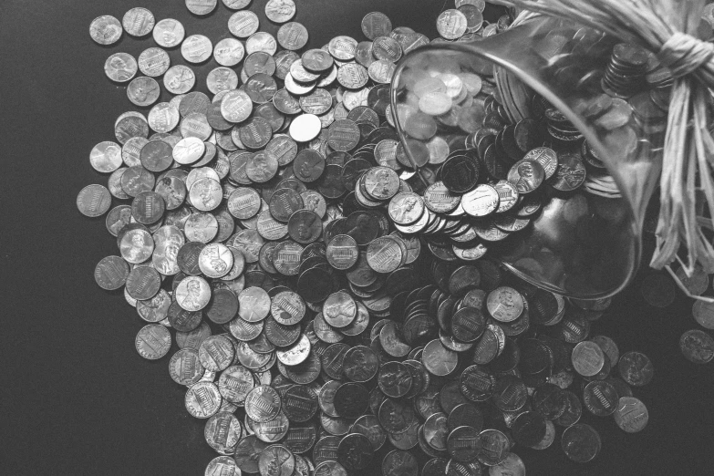 a bag full of coins sitting on top of a table, a black and white photo, by Daniel Lieske, pexels contest winner, visual art, sequins, instagram picture, 1970s photo, farming