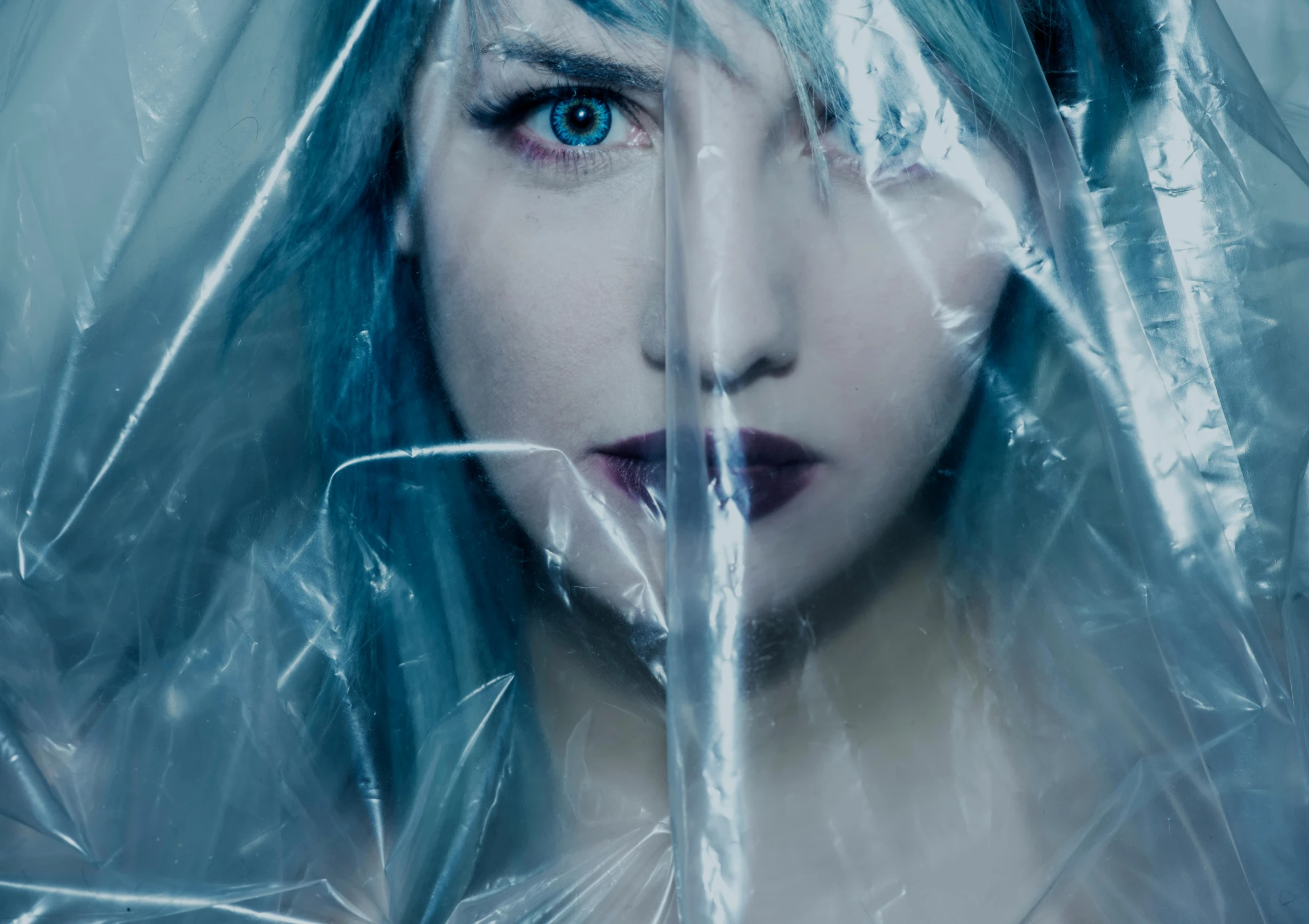 a close up of a person with blue hair, an album cover, inspired by Elsa Bleda, deviantart, hyperrealism, wearing a plastic garbage bag, blade runner film style, annasophia robb as link, entrapped in ice
