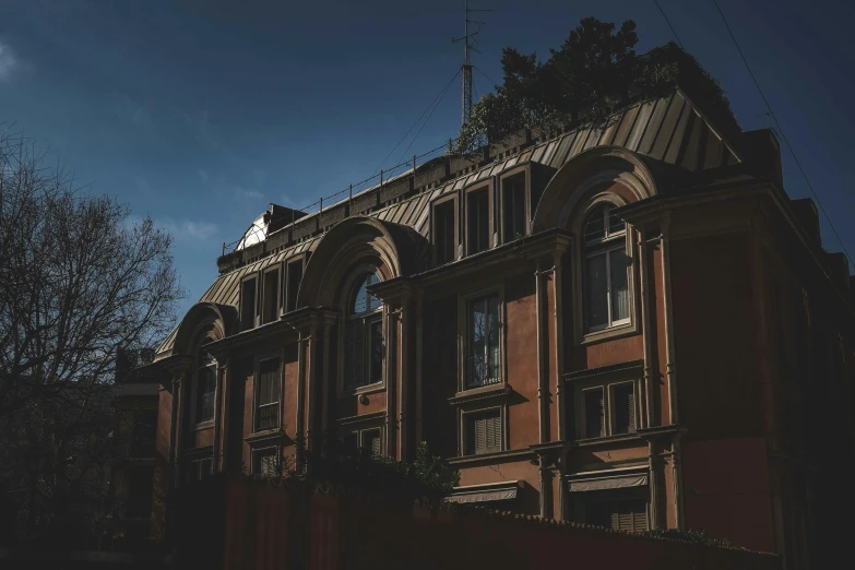 a building with a clock on top of it, a photo, unsplash contest winner, neoclassicism, black and terracotta, profile image, residential area, big arches in the back