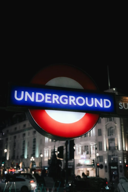 a blue underground sign sitting on the side of a road, by Rupert Shephard, trending on unsplash, circle, london at night, 🚿🗝📝, white background