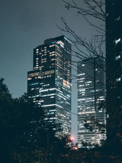 a couple of tall buildings sitting next to each other, a picture, pexels contest winner, ✨🕌🌙, gloom and lights, hyperdetailed photo, 4 k ]
