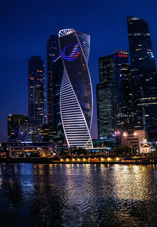 a very tall building next to a body of water, inspired by Vladimir Tatlin, renaissance, at night, skycrapers, square