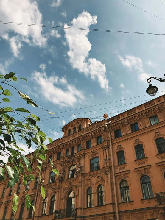 a building with a street light in front of it, a picture, pexels contest winner, neoclassicism, khreschatyk, summer sky, high quality screenshot, multiple stories