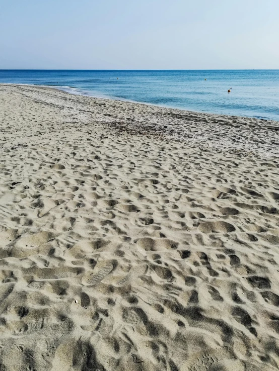 a man standing on top of a sandy beach next to the ocean, marbella, highly detailed # no filter, today\'s featured photograph 4k, walking to the right