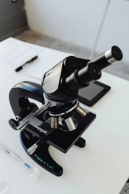 a microscope sitting on top of a white table