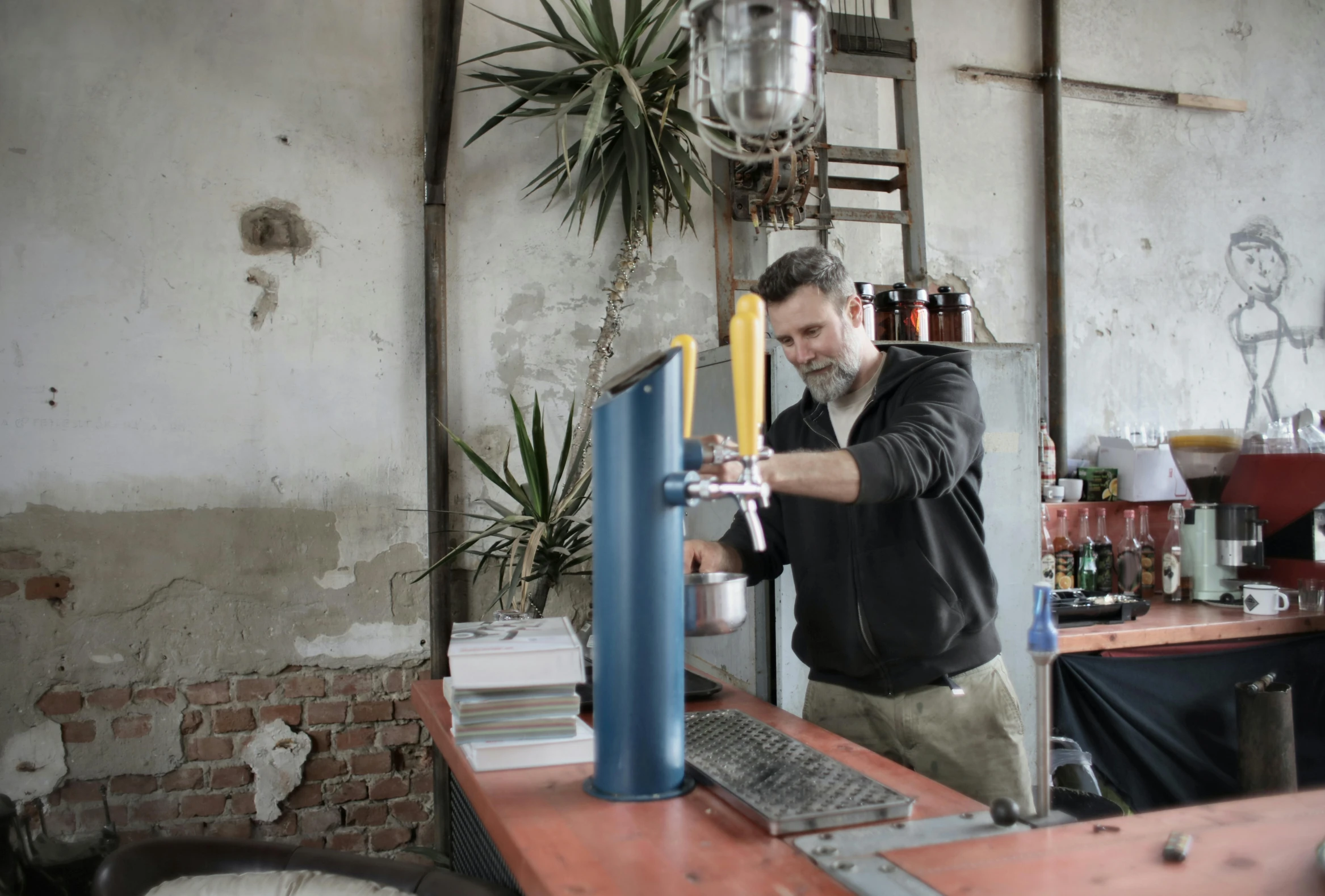 a man that is standing in front of a beer tap, arbeitsrat für kunst, creating a soft, in a warehouse, ignant, al fresco