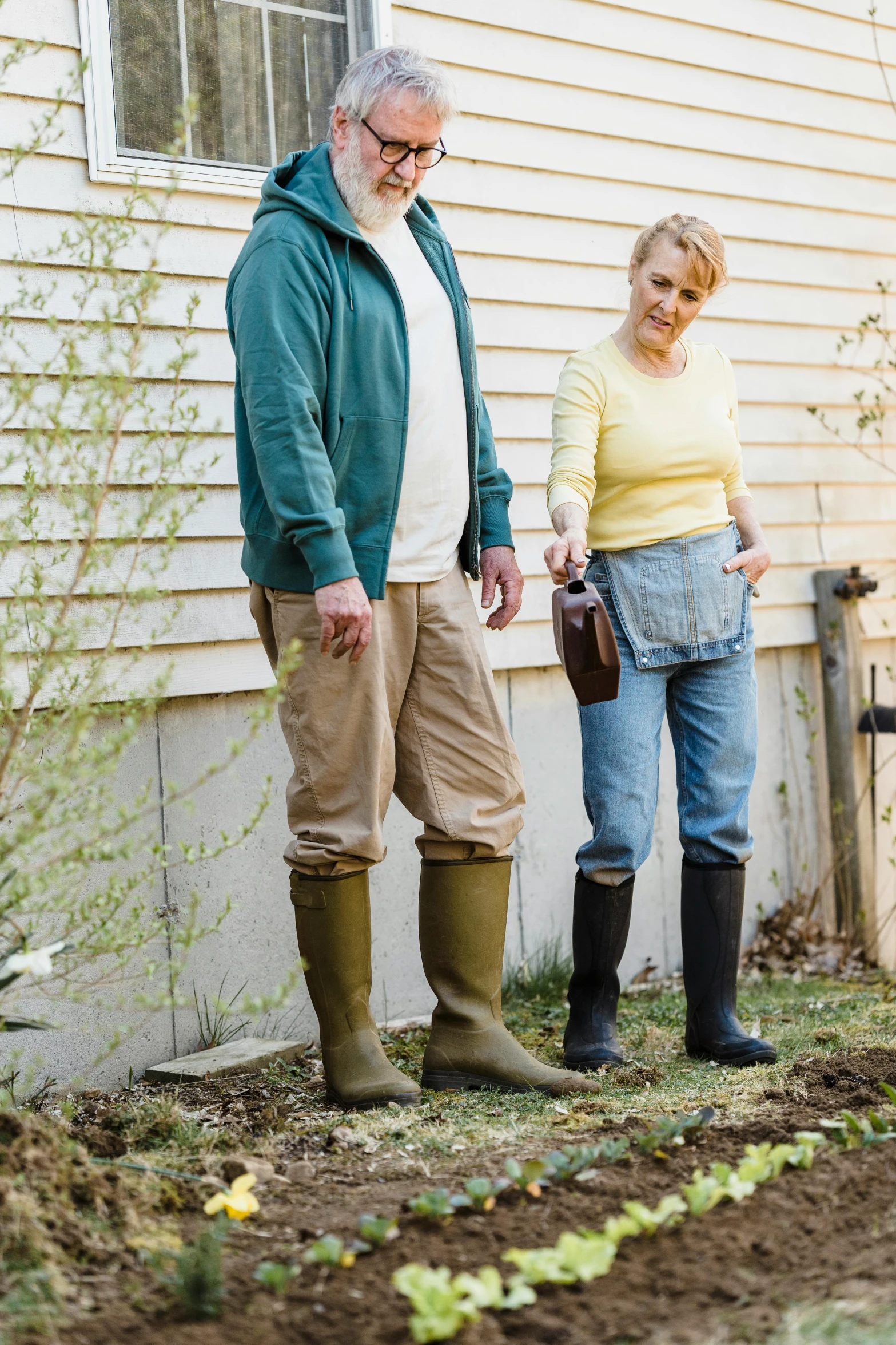 a couple of people that are standing in the dirt, garden at home, wearing boots, profile image, utility