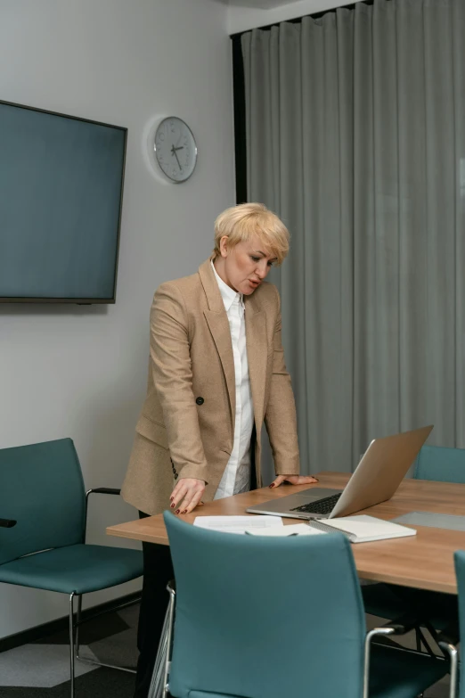 a man standing in front of a laptop computer, trending on pexels, renaissance, blonde woman, in a meeting room, sitting alone, russian academic