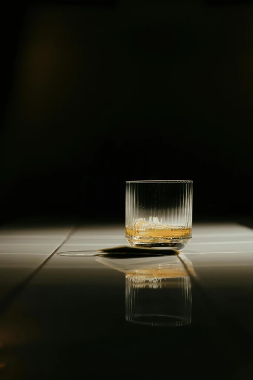 a glass of whiskey sitting on top of a table, by Andries Stock, minimalism, slightly pixelated, promo image, softly shadowed, multiple stories