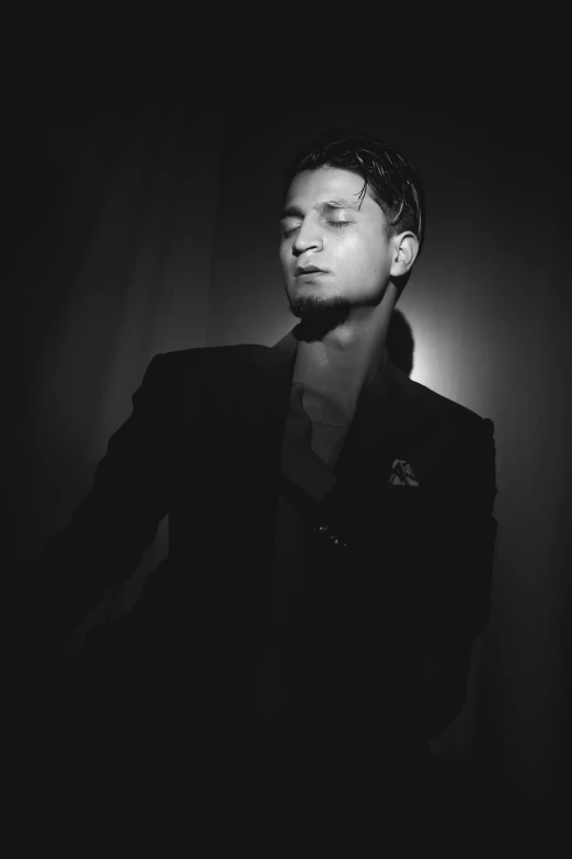 a black and white photo of a man in a suit, inspired by Dmitry Levitzky, jeremy renner, ranjit ghosh, dr zeus, sensuous