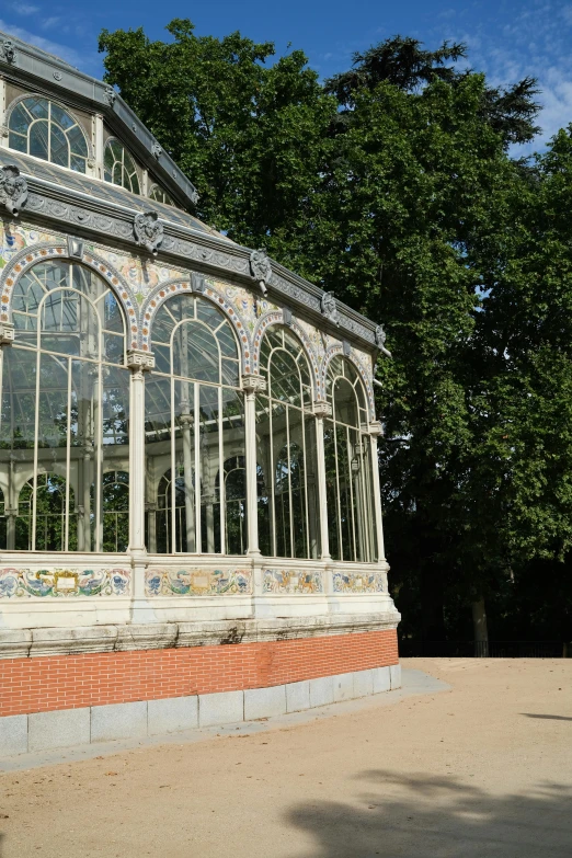 a large glass building sitting in the middle of a park, inspired by Luis Paret y Alcazar, unsplash, art nouveau, 2 5 6 x 2 5 6 pixels, glass greenhouse, madrid, les catacombes