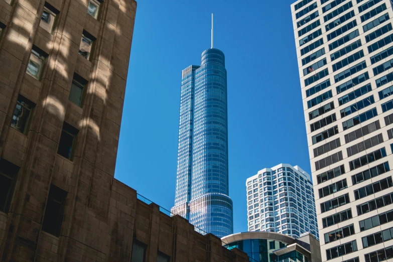 a couple of tall buildings sitting next to each other, by Jan Rustem, pexels contest winner, hurufiyya, trump tower, frank lloyd wright, from wheaton illinois, sunny day