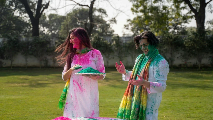 a couple of women standing on top of a lush green field, pexels contest winner, action painting, holi festival of rich color, wearing a kurta, covered in white flour, profile image