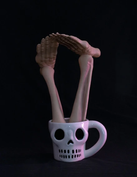 a cup with two bones sticking out of it, a surrealist sculpture, inspired by Robert Mapplethorpe, unsplash, pose(arms up + happy), 5 fingers). full body realistic, 8k octae render photo, halloween
