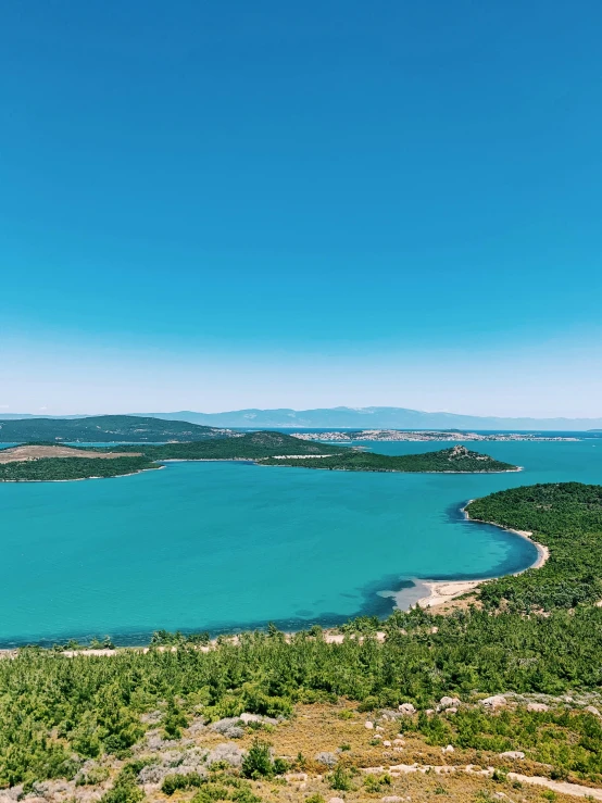 a large body of water surrounded by trees, pexels contest winner, croatian coastline, cyan and green, panorama distant view, high quality product image”