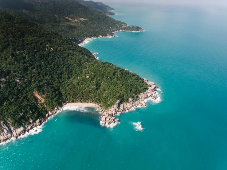 an aerial view of an island in the middle of the ocean, by Seb McKinnon, pexels contest winner, abel tasman, jungle setting, sea - green and white clothes, “ aerial view of a mountain