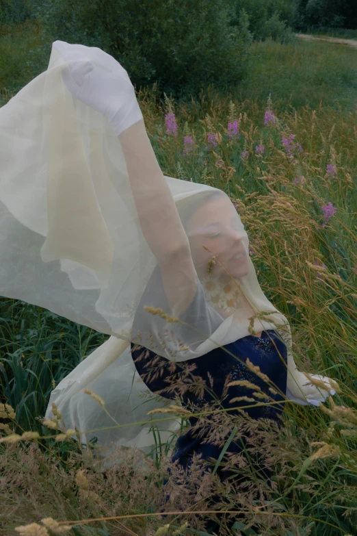 a woman in a white dress sitting in a field, an album cover, inspired by Anna Füssli, unsplash, renaissance, soft translucent fabric folds, dressed in plastic bags, detail shot, silks