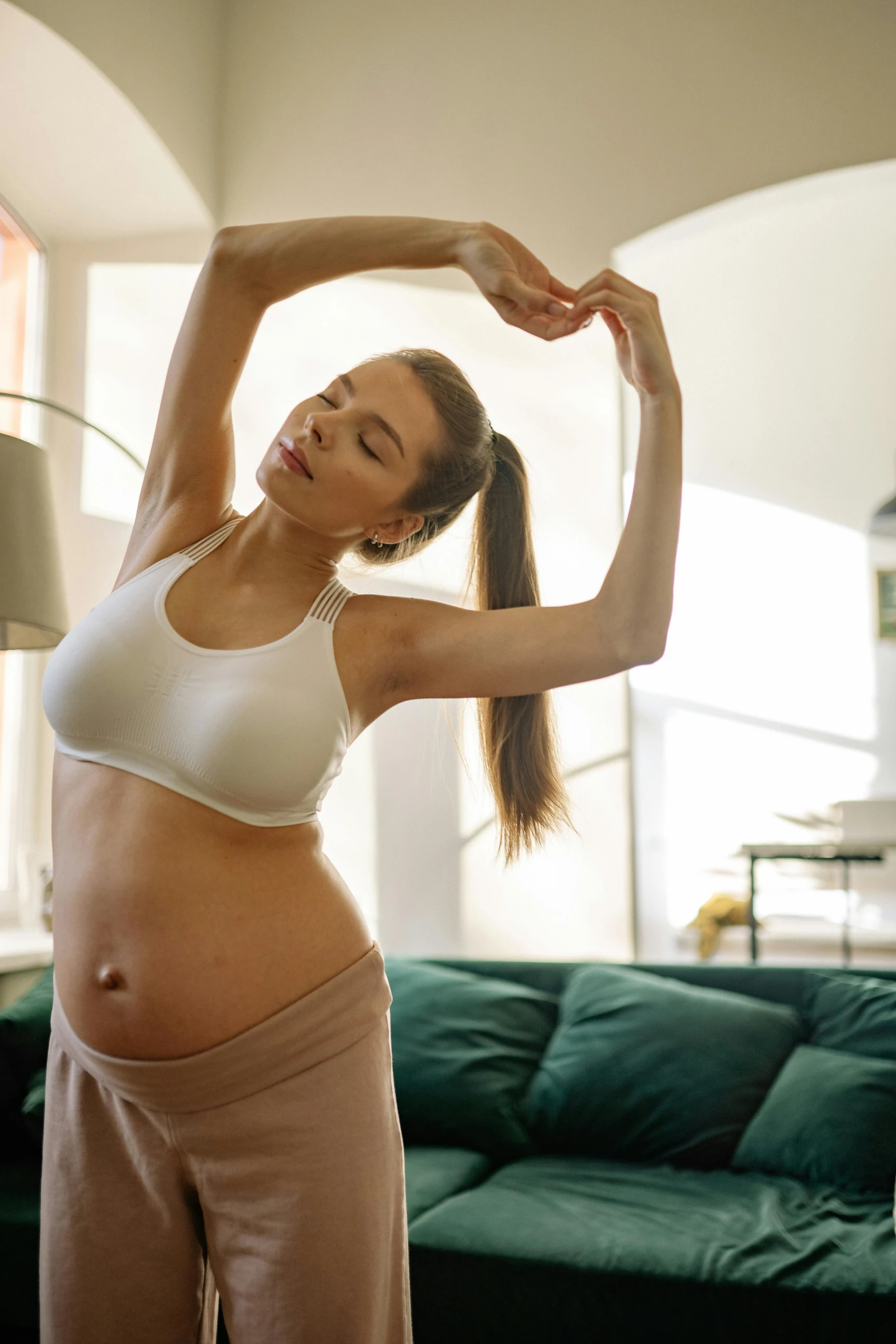 a pregnant woman stretching her arms in a living room, shutterstock, figuration libre, hearts, perfect body shape, bump mapped, square