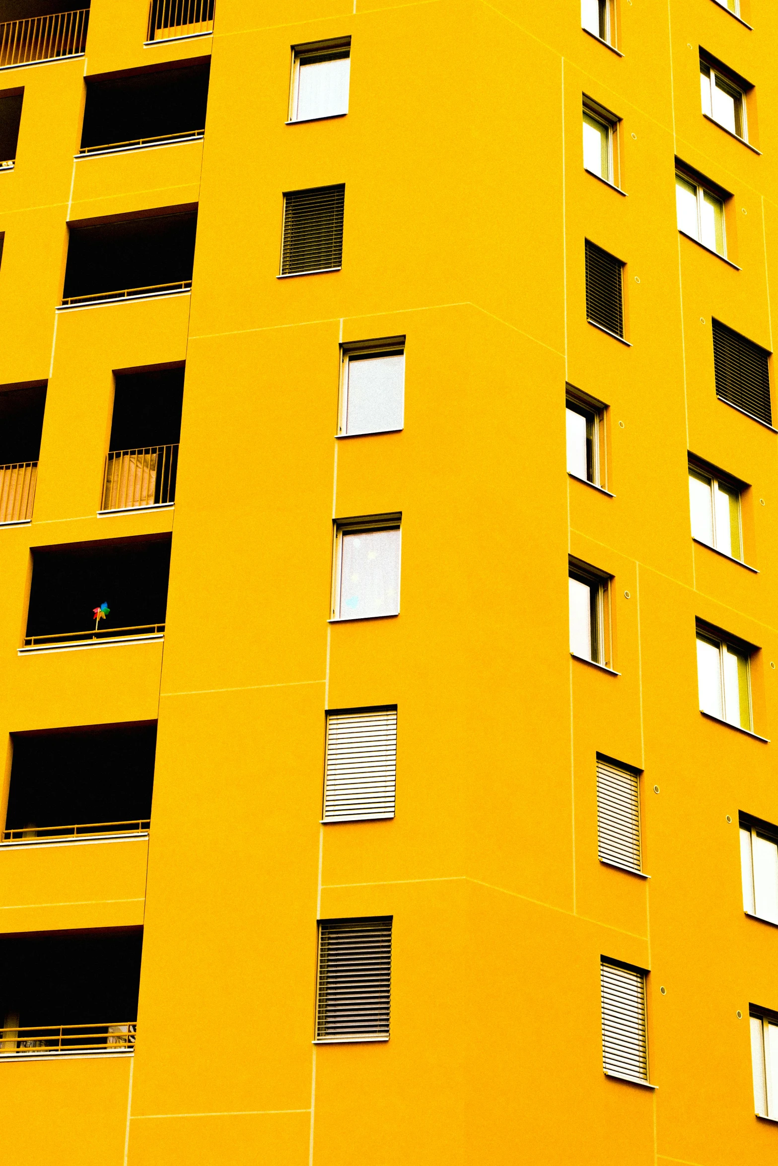 a tall yellow building with lots of windows, pexels contest winner, apartment, 8k 50mm iso 10, complementary colours, scholar