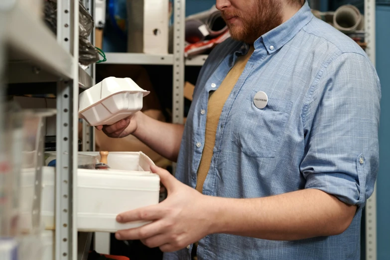 a man that is standing in front of a shelf, hand holding cap brim, inspect in inventory image, non-binary, hardware