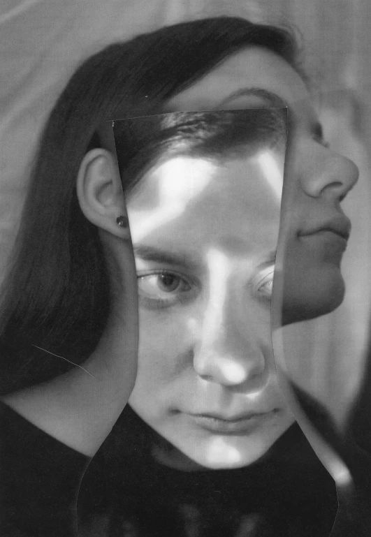 a woman looking at her reflection in a mirror, a black and white photo, inspired by Dora Maar, front face asymmetrical, image split in half, contorted, androgynous face