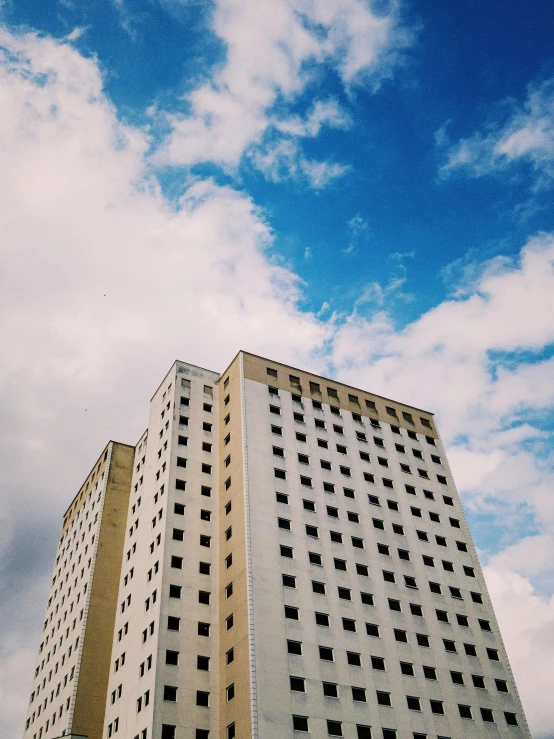 a couple of tall buildings sitting next to each other, inspired by Thomas Struth, unsplash, brutalism, trip to legnica, low quality photo, summer sky, 90's photo