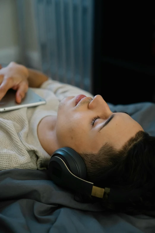 a man laying on a bed with a laptop and headphones, trending on pexels, renaissance, still frame from a movie, headphones on head, ilustration, lgbtq