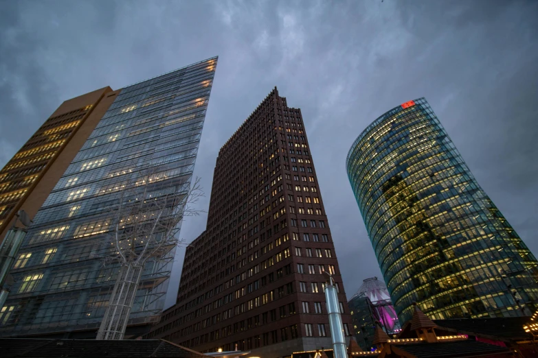 a group of tall buildings sitting next to each other, by Sebastian Spreng, pexels contest winner, mies van der rohe, cold lighting, marketsquare, low dutch angle