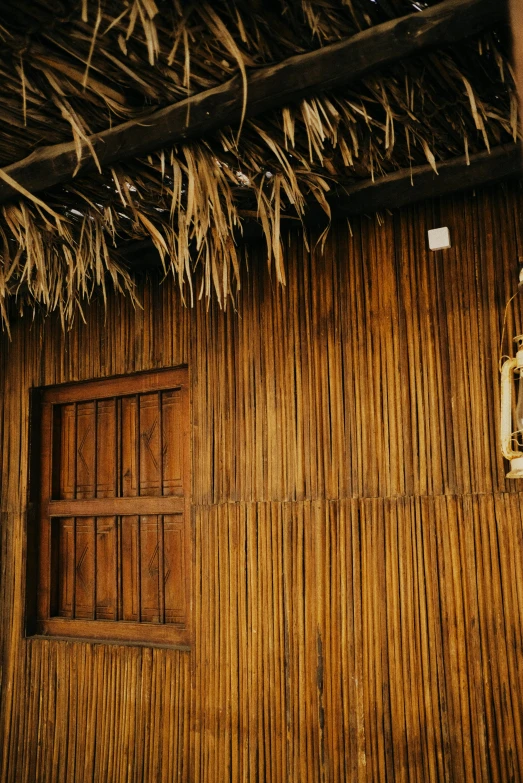 a bamboo hut with a lantern hanging from the roof, an album cover, trending on unsplash, renaissance, wall structure, brown, gold, sukkot