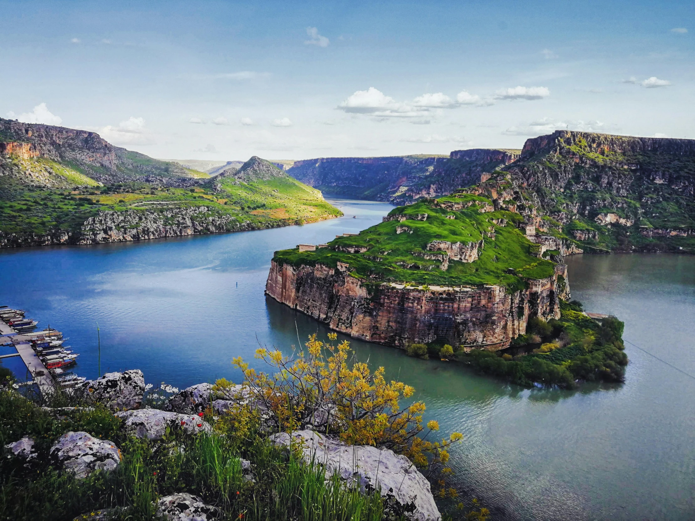 a large body of water surrounded by mountains, by Muggur, pexels contest winner, art nouveau, kurdistan, sharp cliffs, hasbulla magomedov, conde nast traveler photo