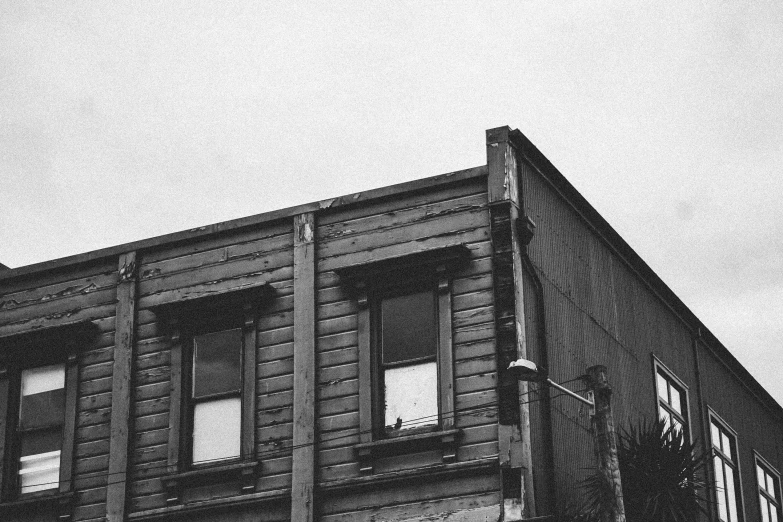a black and white photo of an old building, by Adam Rex, wellington, wooden buildings, vintage aesthetic, ignant