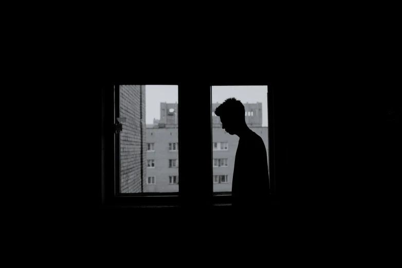 a silhouette of a man standing in front of a window, a black and white photo, sad men, instagram post, album cover, silhouettes of people