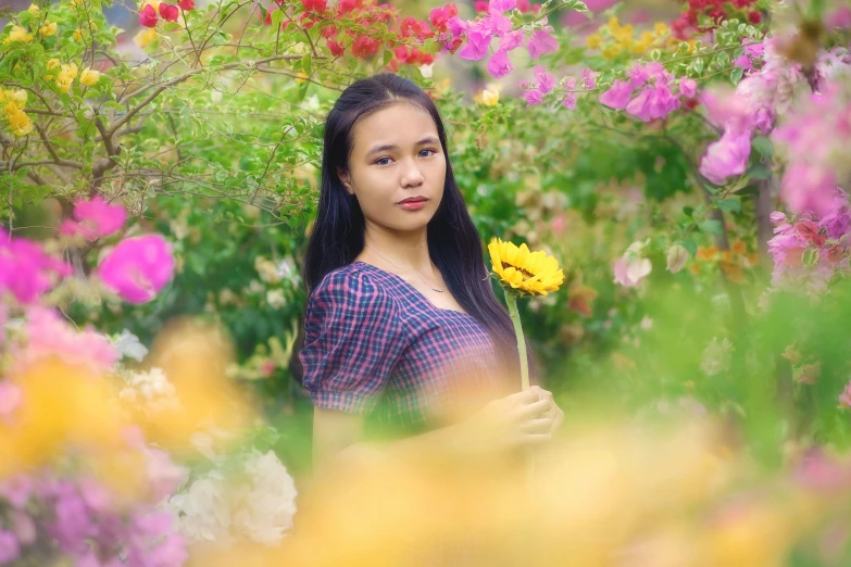 a woman holding a flower in a field of flowers, pexels contest winner, avatar image, young asian girl, college, multicolored