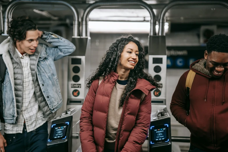 a group of people standing next to each other, by Carey Morris, pexels contest winner, mta subway entrance, future inflatable jacket, tessa thompson, beautiful female