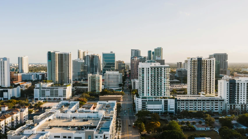 an aerial view of a city with tall buildings, by Carey Morris, unsplash contest winner, renaissance, fallout 5 : miami, 3 / 4 wide shot, white buildings, late afternoon