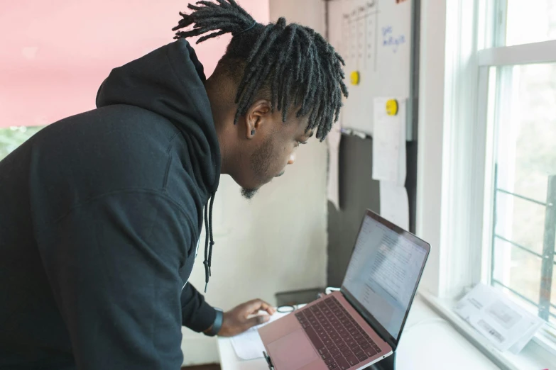 a man with dreadlocks working on a laptop, by Carey Morris, pexels contest winner, standing in class, bottom angle, profile image, thumbnail