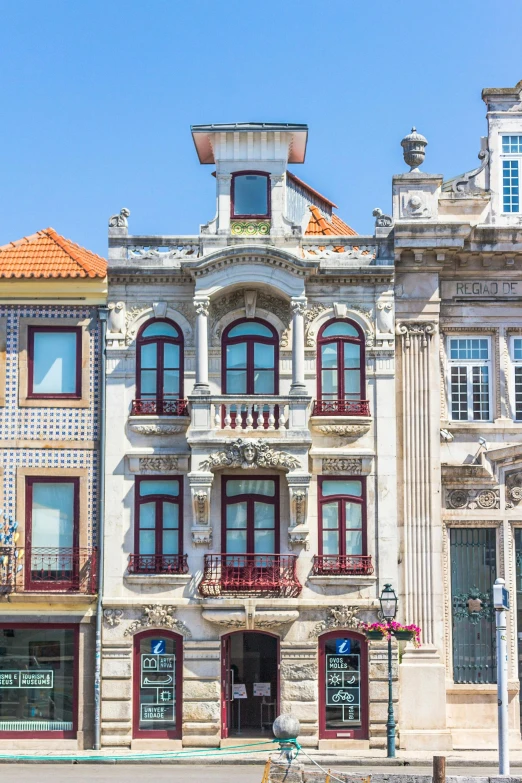 a couple of buildings that are next to each other, inspired by Nadir Afonso, pexels contest winner, art nouveau, colonial style, stone facade, front elevation, slide show