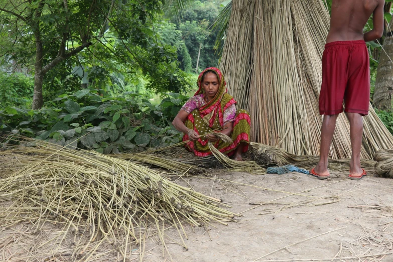 a couple of people that are standing in the dirt, weaving, in jungle, bangladesh, avatar image