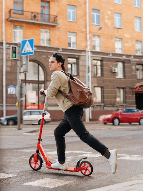 a man riding a scooter on a city street, pexels contest winner, happening, with a backpack, avatar image, 000 — википедия, red and brown color scheme